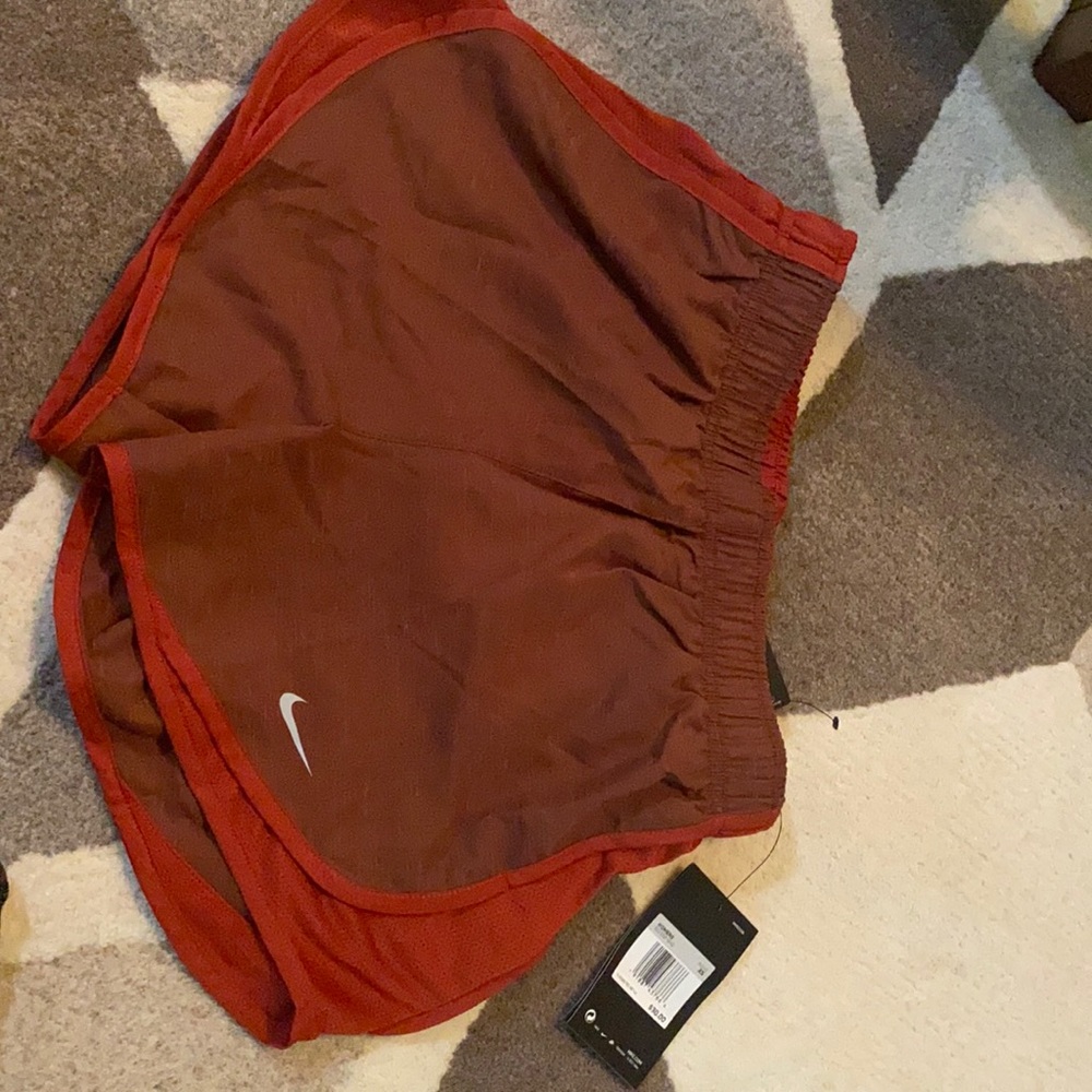 Maroon/red dri fit Nike running shorts.